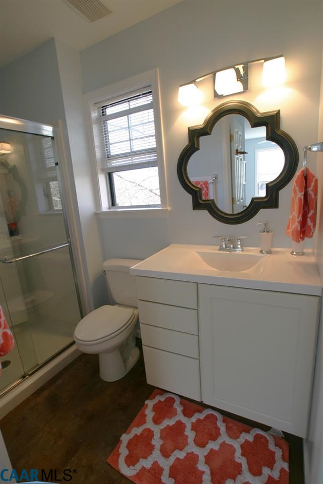 803 Harris Road Charlottesville, VA 22902 - Photo 11 of 15 a bathroom with a sink mirror vanity and toilet