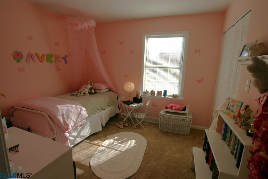803 Harris Road Charlottesville, VA 22902 - Photo 13 of 15 a bed room with a bed and a chair