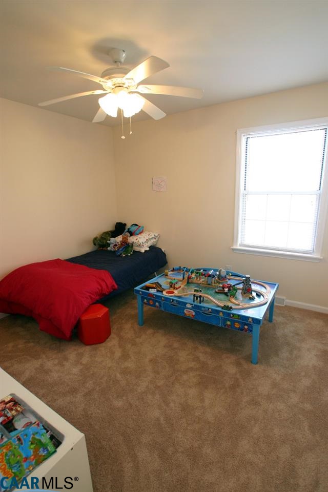 803 Harris Road Charlottesville, VA 22902 - Photo 14 of 15 a bed room with a bed and a chandelier