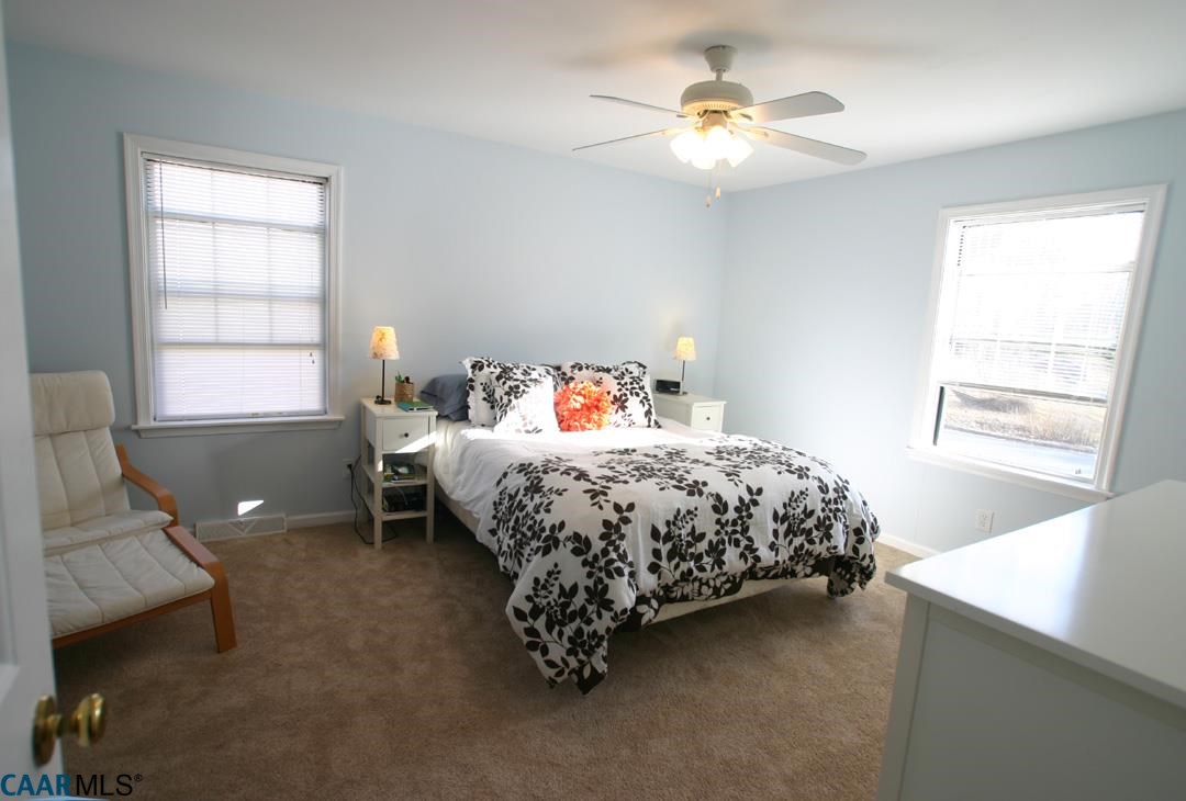 803 Harris Road Charlottesville, VA 22902 - Photo 10 of 15 a bedroom with a bed and a chandelier