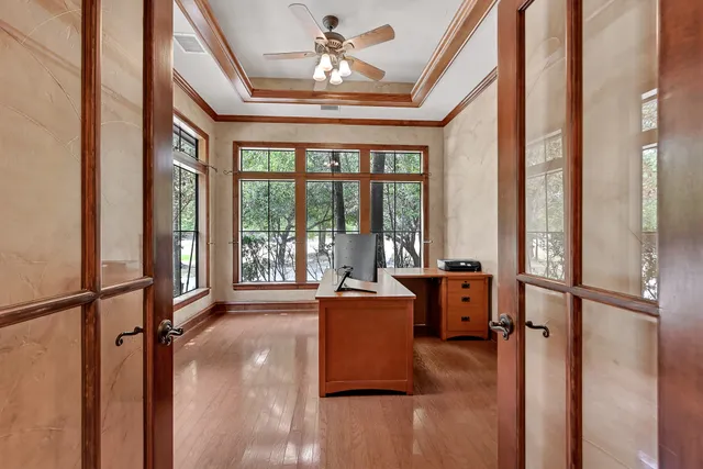 a dining room with furniture and a large window
