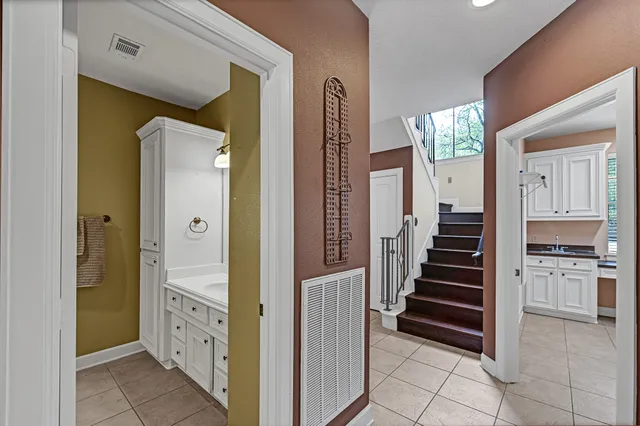 a view of a hallway with wooden floor and staircase