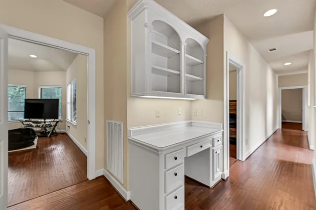 a kitchen with a sink cabinets and wooden floor
