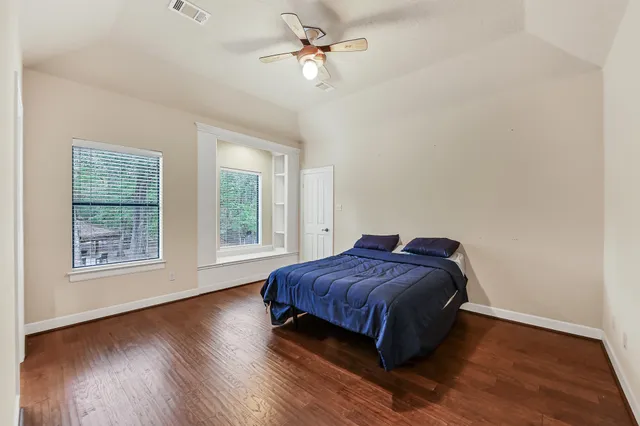 a living room with a bed furniture and a window