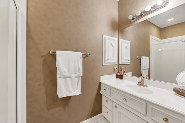 a bathroom with a sink vanity and a mirror
