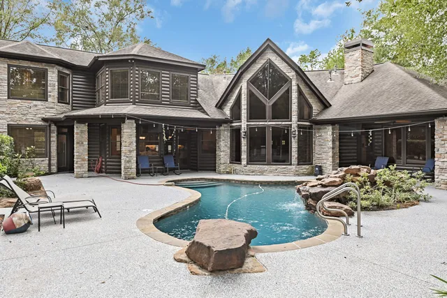 a view of a house with backyard porch and sitting area