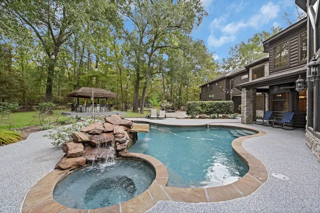 a view of a house with swimming pool and sitting area