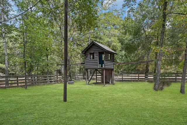 a front view of a house with a yard table and a large tree