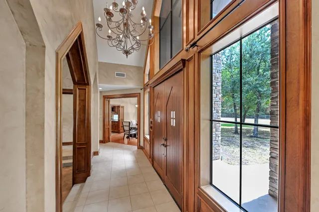 a view of a hallway with wooden floor and door