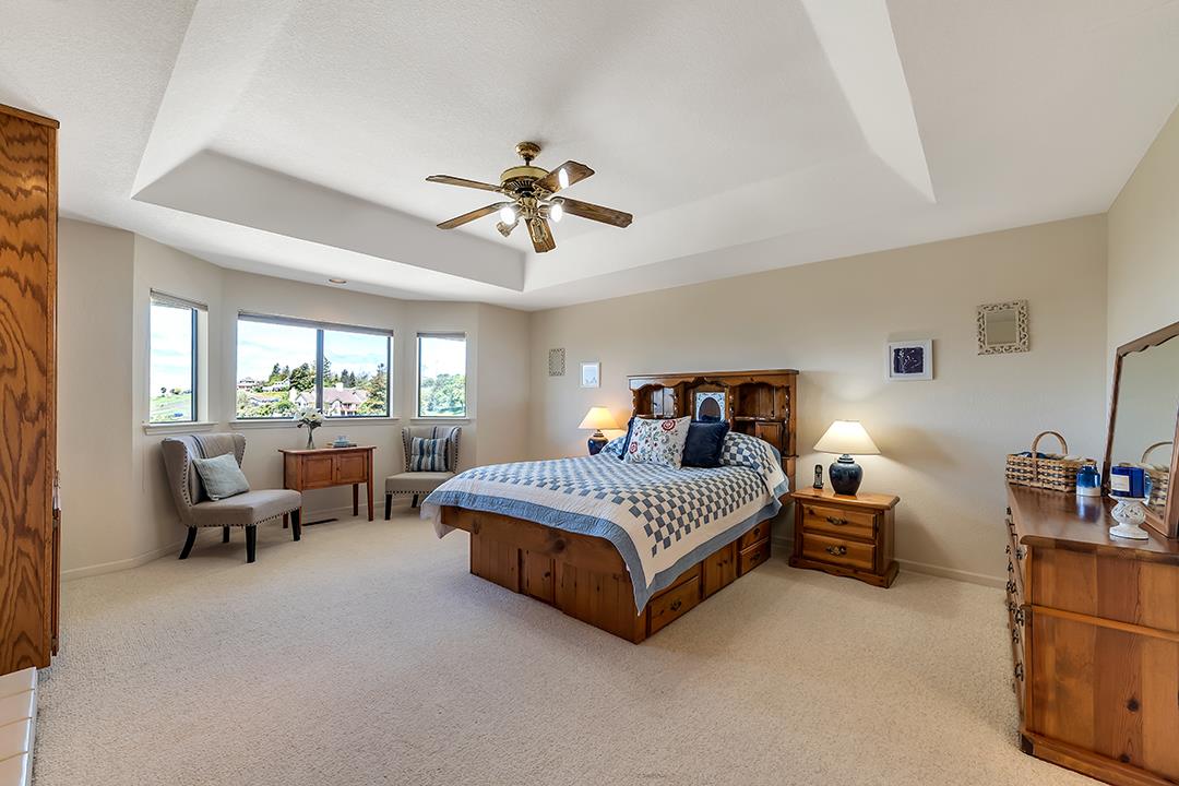 3130 Springview Lane San Jose, CA 95140 - Photo 11 of 47 a spacious bedroom with a bed and a chandelier