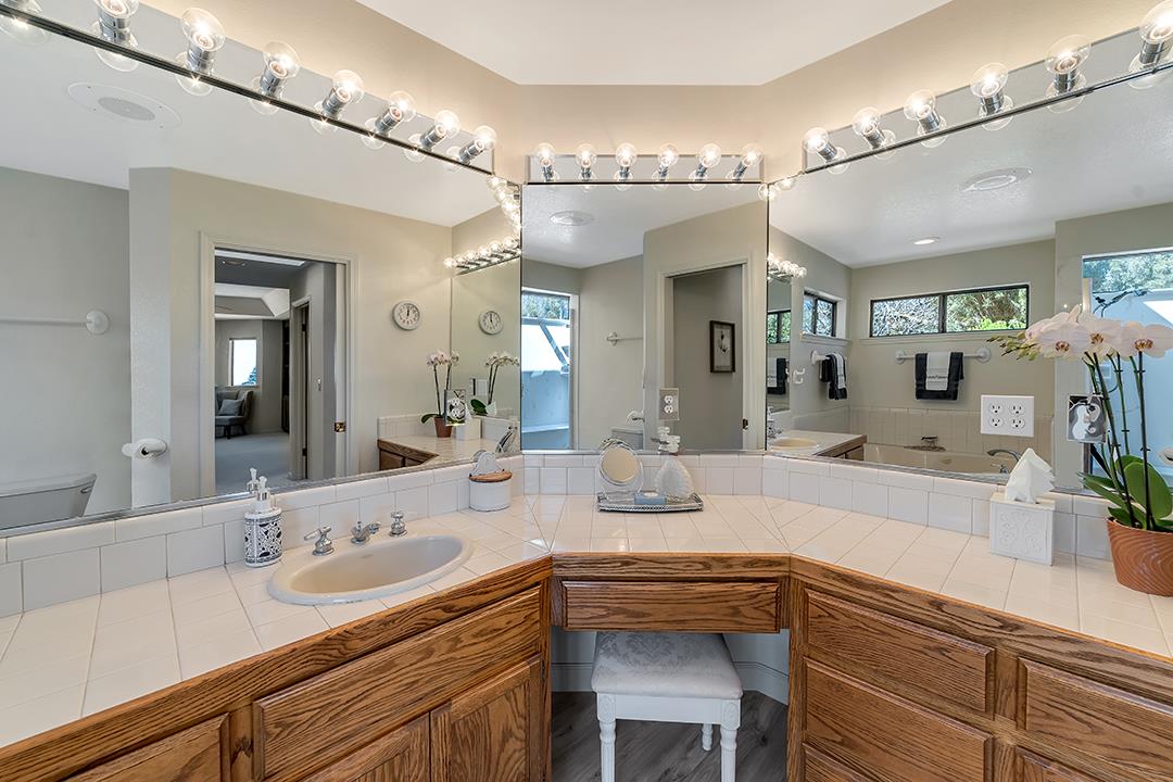 3130 Springview Lane San Jose, CA 95140 - Photo 12 of 47 a spacious bathroom with a sink a large mirror and vanity