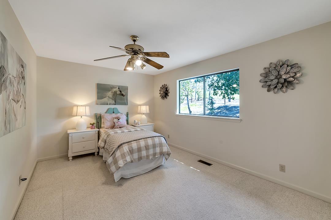 3130 Springview Lane San Jose, CA 95140 - Photo 17 of 47 a spacious bedroom with a bed and a chandelier