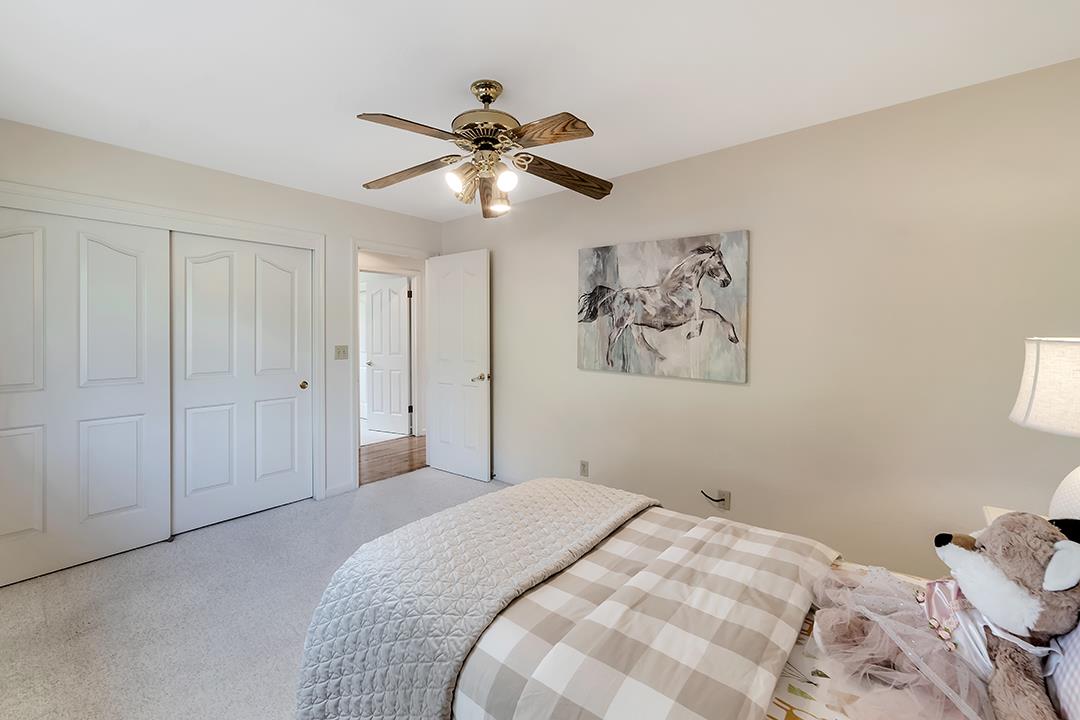 3130 Springview Lane San Jose, CA 95140 - Photo 18 of 47 a bedroom with a large bed and a chandelier