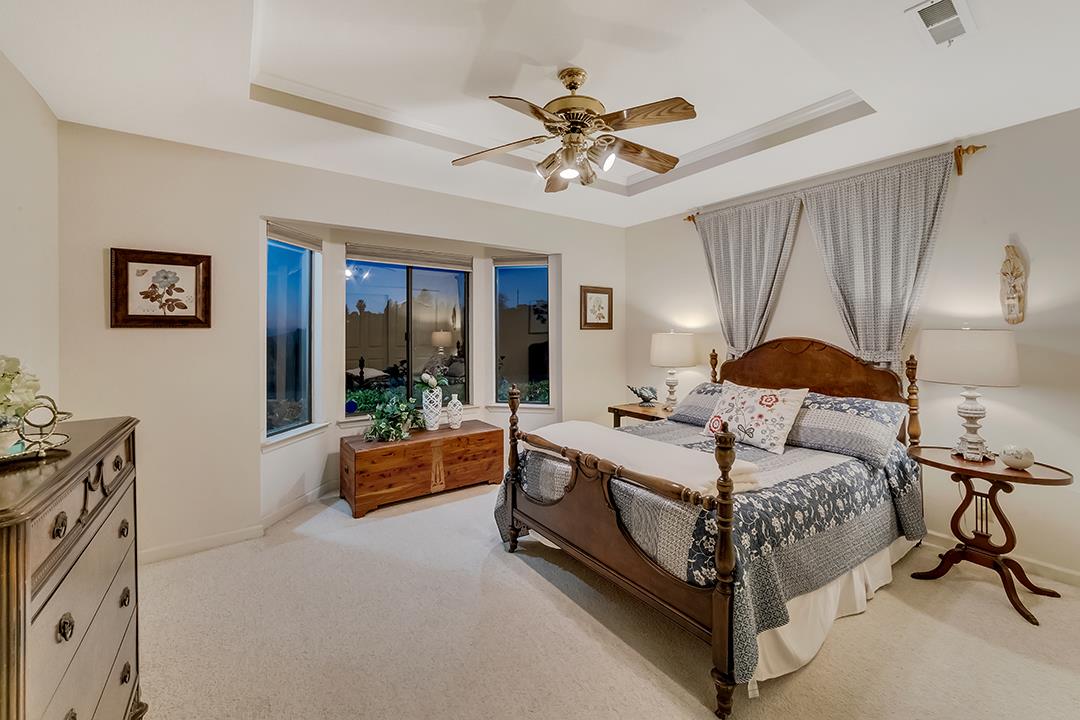 3130 Springview Lane San Jose, CA 95140 - Photo 19 of 47 a bedroom with a bed and a chandelier