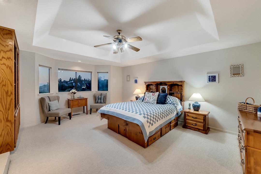 3130 Springview Lane San Jose, CA 95140 - Photo 24 of 47 a spacious bedroom with a bed and a chandelier