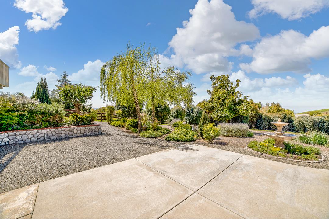 3130 Springview Lane San Jose, CA 95140 - Photo 36 of 47 a view of a garden with a building in the background