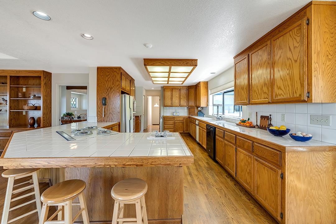3130 Springview Lane San Jose, CA 95140 - Photo 7 of 47 a large kitchen with a table and chairs in it