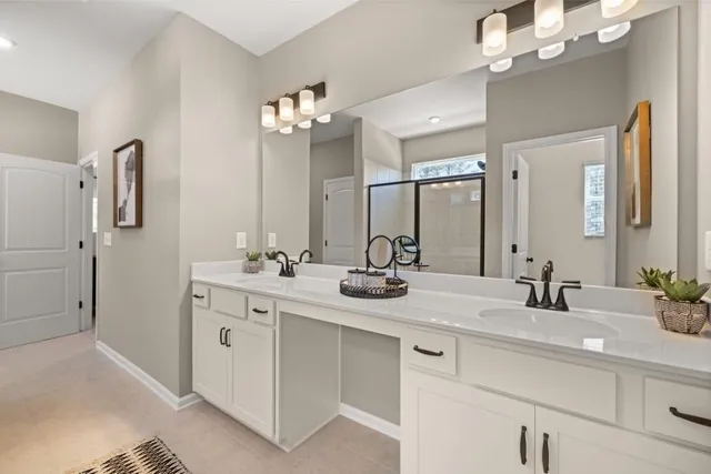 a bathroom with a double vanity sink a mirror and a shower