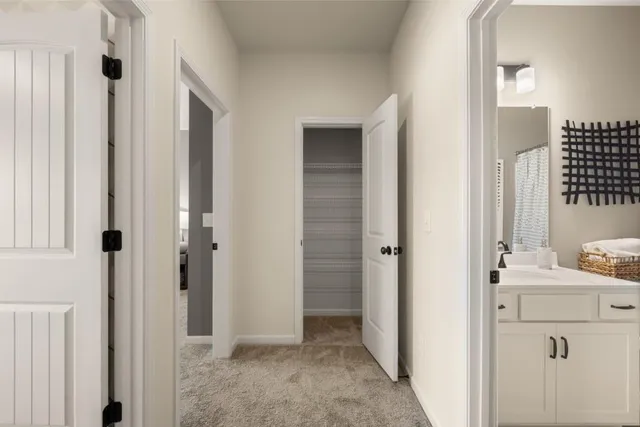 a view of bathroom with a sink mirror and window