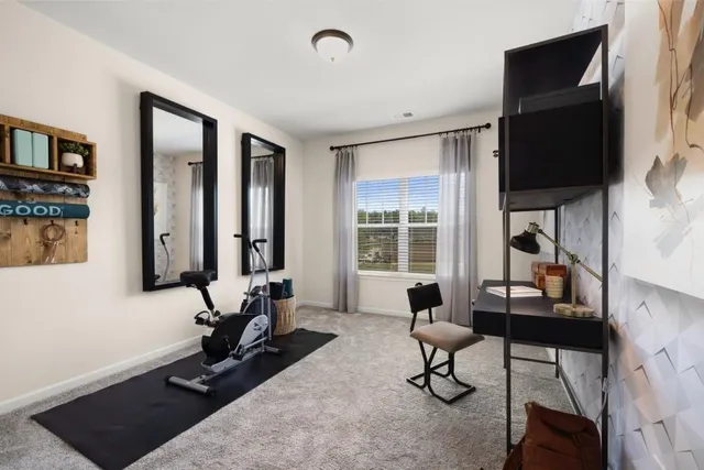 a view of a livingroom with workspace and a couch