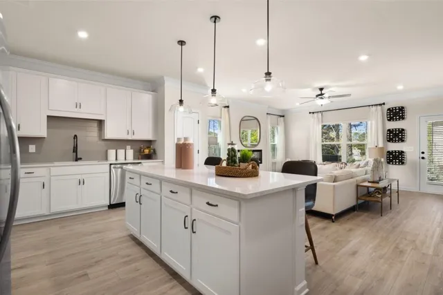 a kitchen with white cabinets and white appliances