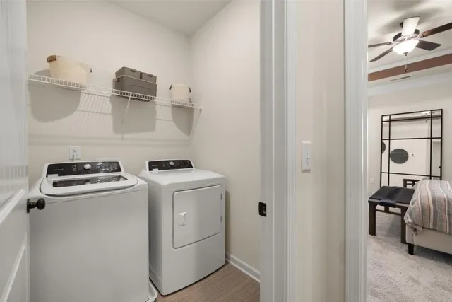 a view of washer and dryer with kitchen in the background