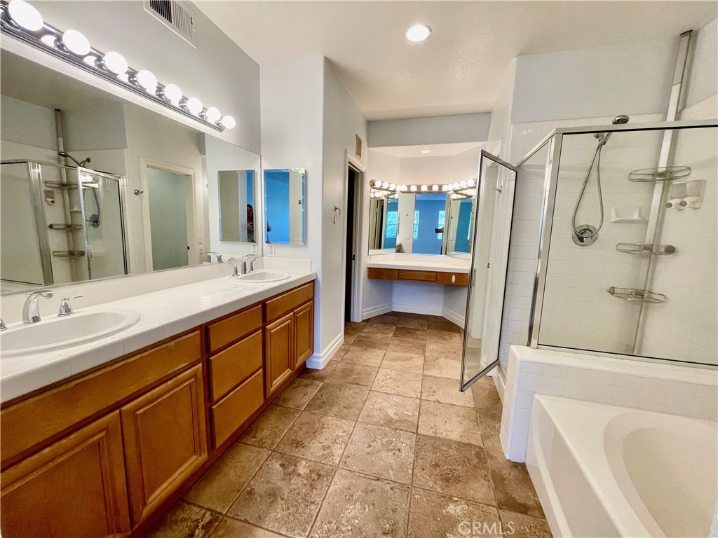 26 Cabazon Irvine, CA 92602 - Photo 8 of 9 a large bathroom with a double vanity sink toilet mirror and bathtub