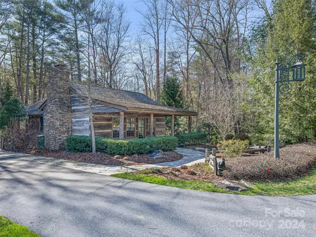 a front view of a house with a yard and outdoor seating
