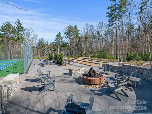 a view of a patio with chairs and a fire pit