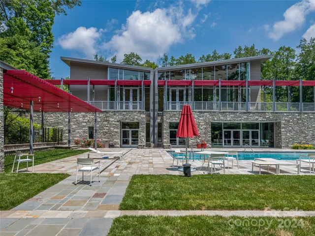 a view of swimming pool with a patio and a yard