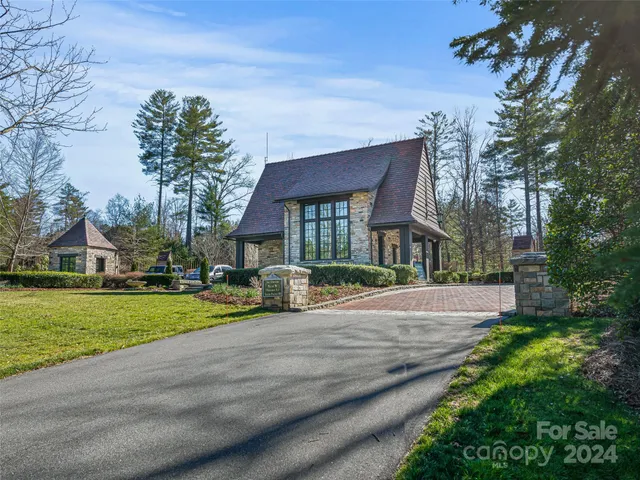 a view of a house with a yard and pathway