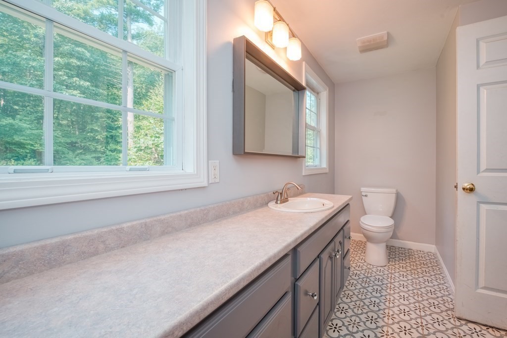 365 Turnpike Road Ashby, MA 01431 - Photo 16 of 37 a bathroom with a sink a toilet and a window