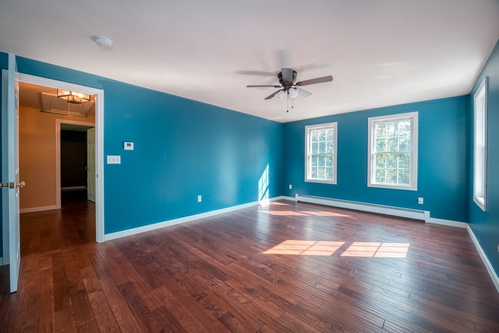 365 Turnpike Road Ashby, MA 01431 - Photo 21 of 37 a view of empty room with wooden floor and fan