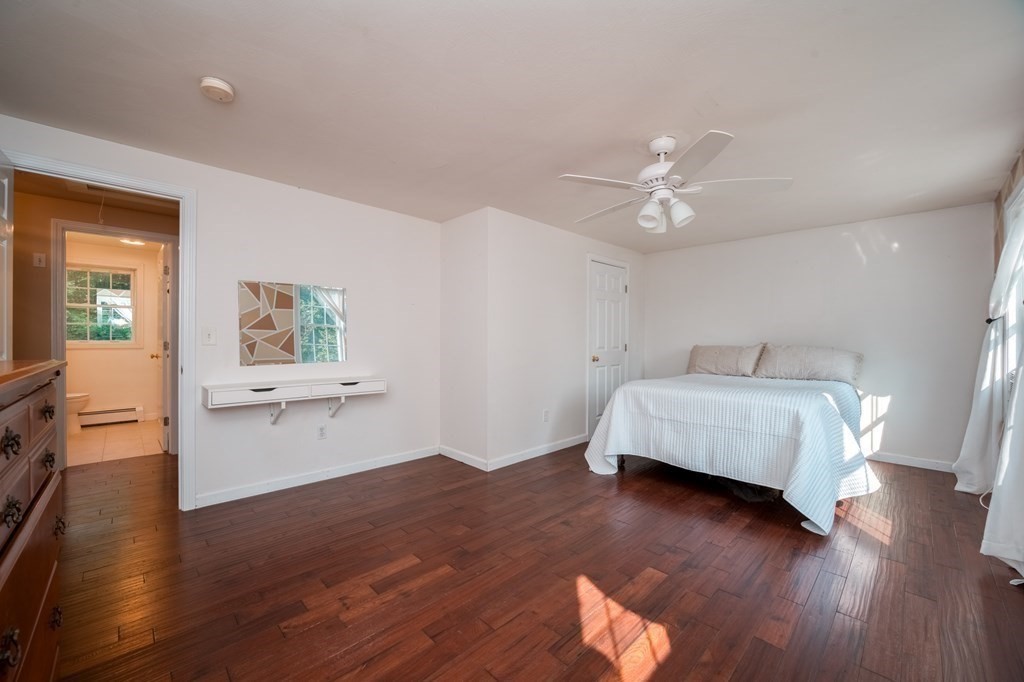 365 Turnpike Road Ashby, MA 01431 - Photo 26 of 37 a bedroom with a bed and wooden floor