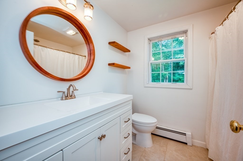 365 Turnpike Road Ashby, MA 01431 - Photo 27 of 37 a bathroom with a sink a toilet and a mirror