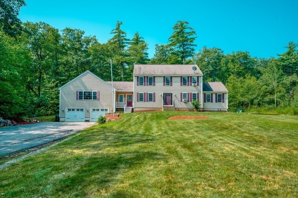 365 Turnpike Road Ashby, MA 01431 - Photo 31 of 37 a front view of a house with a yard and trees