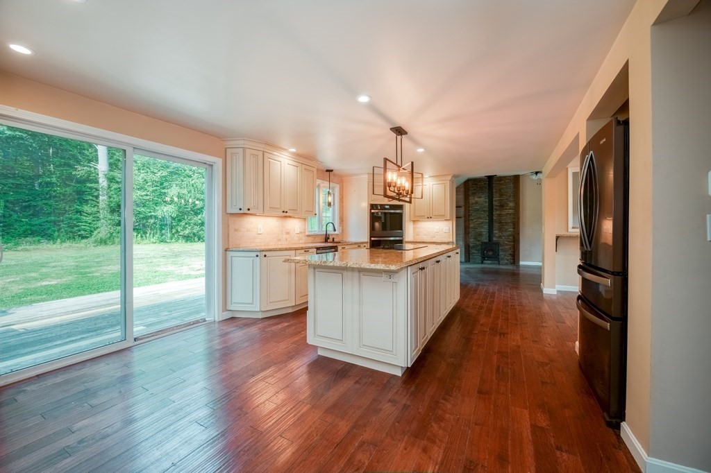365 Turnpike Road Ashby, MA 01431 - Photo 4 of 37 a kitchen with stainless steel appliances wooden floors and large window