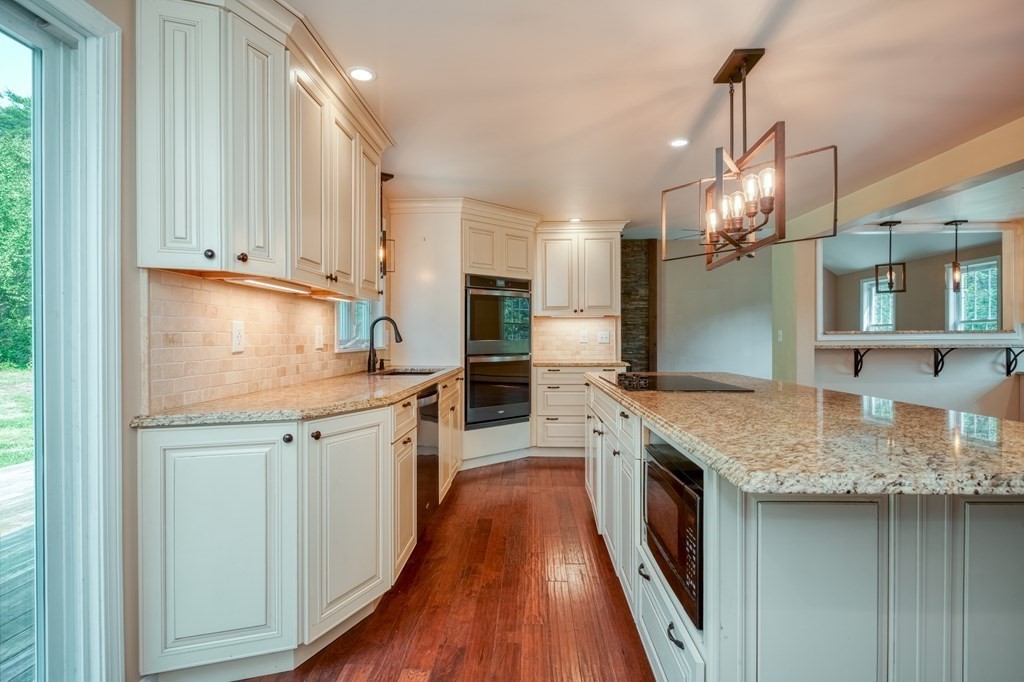 365 Turnpike Road Ashby, MA 01431 - Photo 5 of 37 a kitchen with stainless steel appliances granite countertop a sink stove and refrigerator