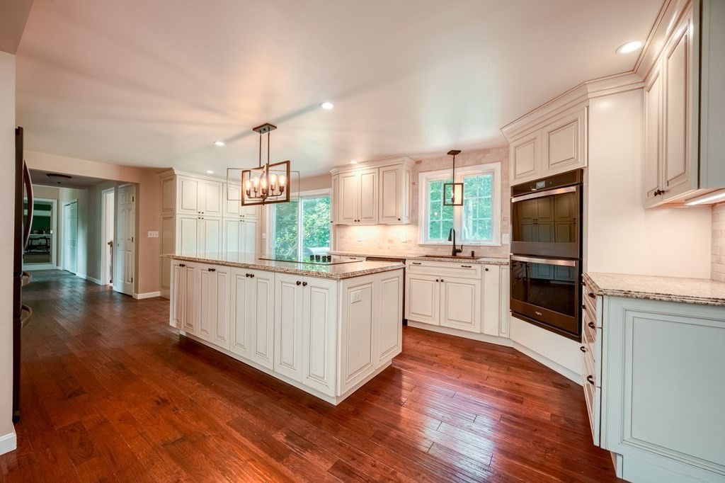 365 Turnpike Road Ashby, MA 01431 - Photo 8 of 37 a kitchen with white cabinets and stainless steel appliances