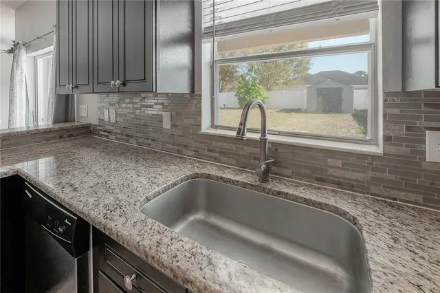 a kitchen with stainless steel appliances granite countertop a refrigerator sink and cabinets
