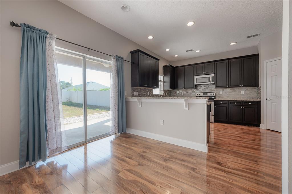 2012 Fern Ridge Court Holiday, FL 34691 - Photo 14 of 54 a view of kitchen with wooden floor and electronic appliances