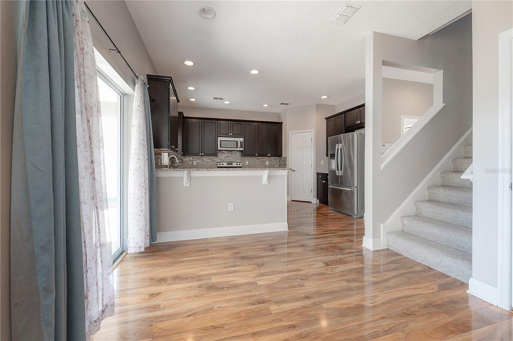2012 Fern Ridge Court Holiday, FL 34691 - Photo 15 of 54 a view of a kitchen with wooden floor and electronic appliances