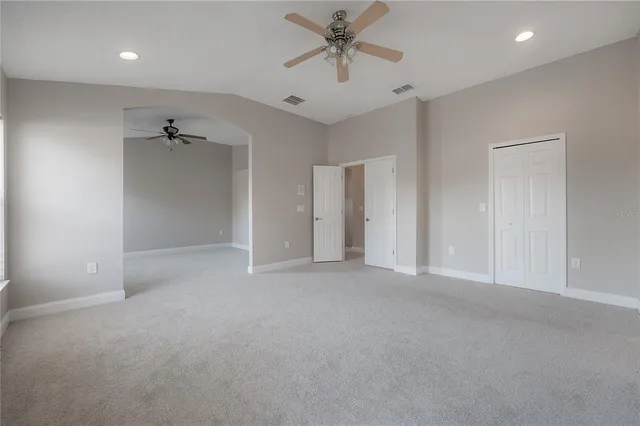 a large bathroom with a large tub sink vanity and granite