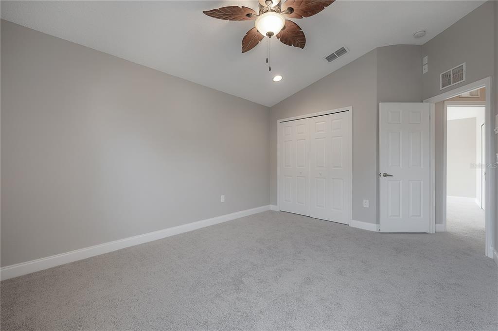 2012 Fern Ridge Court Holiday, FL 34691 - Photo 29 of 54 an empty room with chandelier fan