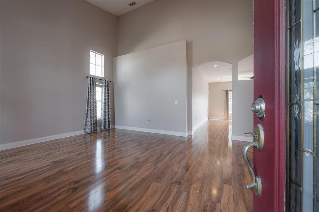 2012 Fern Ridge Court Holiday, FL 34691 - Photo 3 of 54 a view of empty room with wooden floor and fan