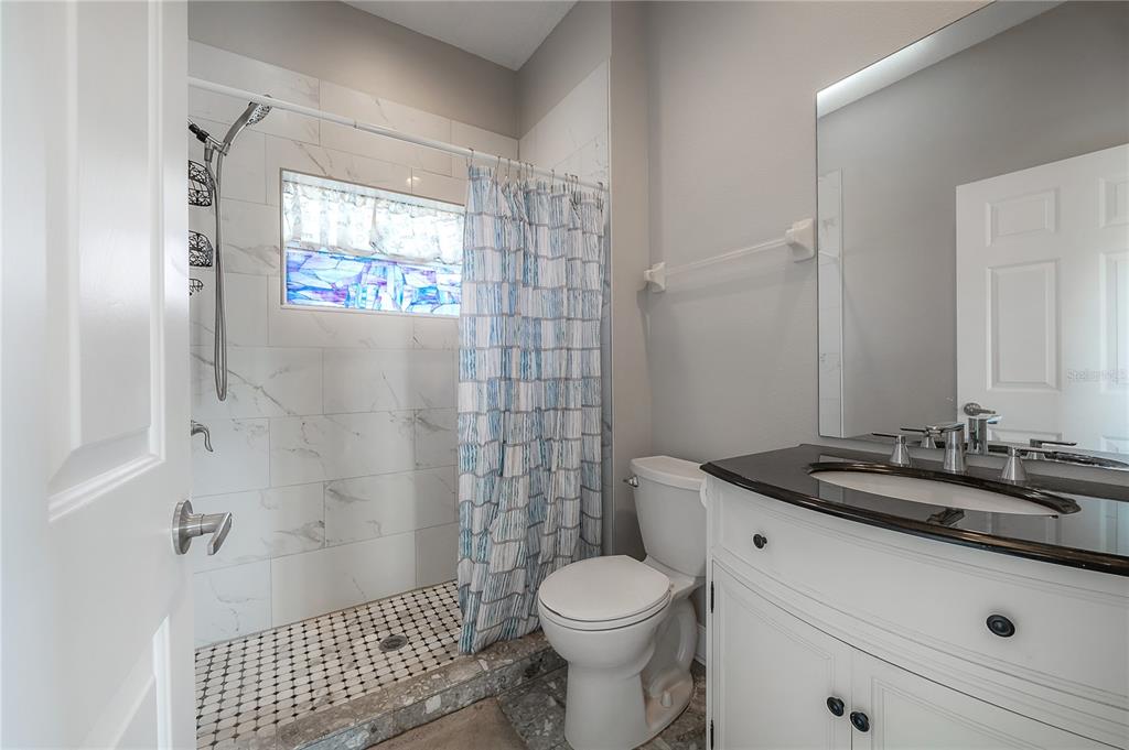 2012 Fern Ridge Court Holiday, FL 34691 - Photo 34 of 54 a bathroom with a sink toilet and shower