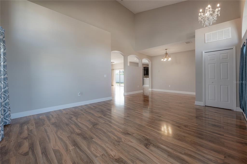 2012 Fern Ridge Court Holiday, FL 34691 - Photo 5 of 54 a view of a room with wooden floor and a kitchen