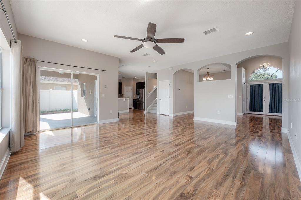 2012 Fern Ridge Court Holiday, FL 34691 - Photo 6 of 54 a view of a hallway with wooden floor and a ceiling fan