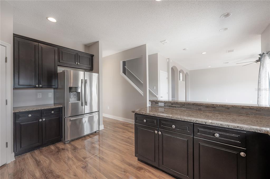 2012 Fern Ridge Court Holiday, FL 34691 - Photo 8 of 54 a kitchen with stainless steel appliances granite countertop a refrigerator and a sink