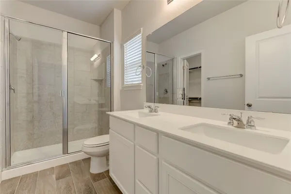 a bathroom with a sink toilet and shower